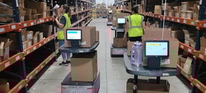 AMRs in aisle of warehouse