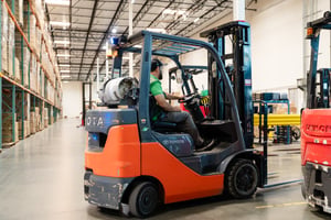 An image of a forklift in a warehouse facility
