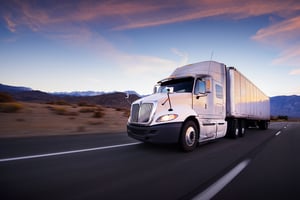 An image of the front of a tractor trailer truck. 